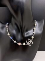 A white gold, blue and pink heart-shaped necklace